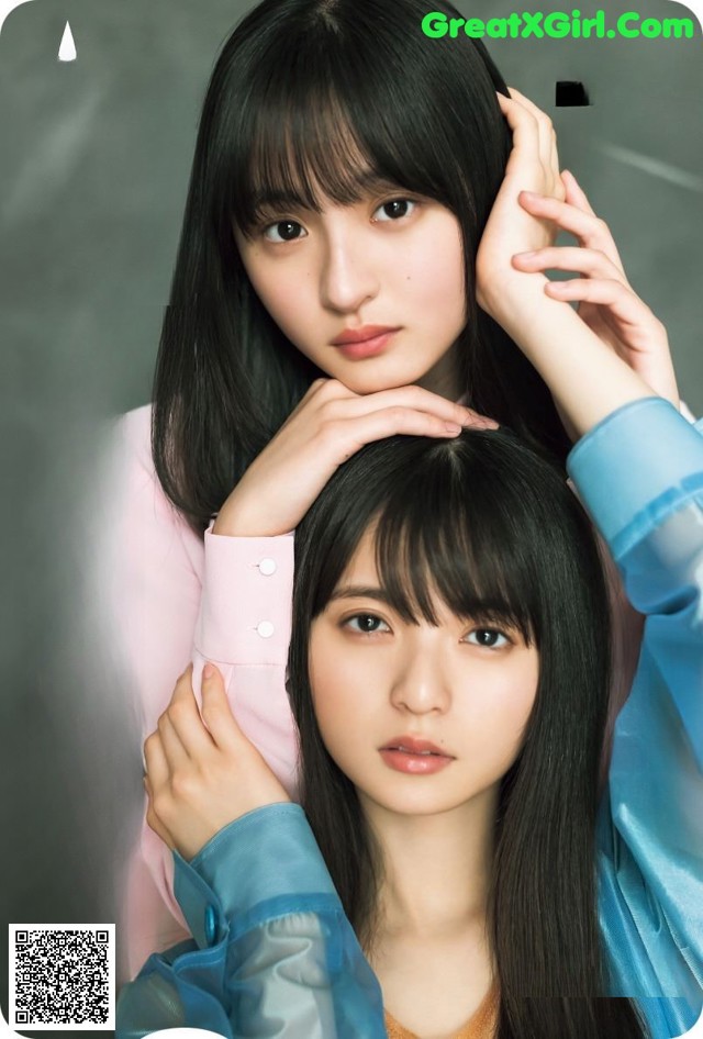 A couple of young women standing next to each other.