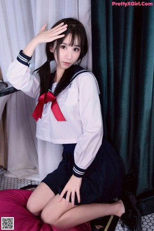 A woman in a school uniform posing for a picture.