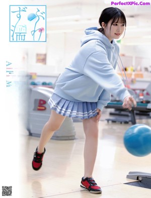 A woman holding a blue ball in a magazine.