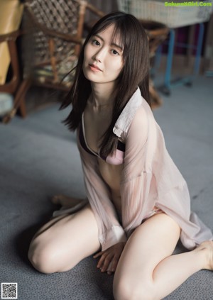 A woman in a blue kimono is posing for the camera.