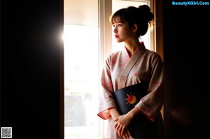 A woman in a colorful dress posing for a picture.