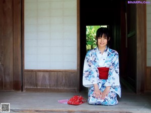 A woman with long black hair is posing for a picture.