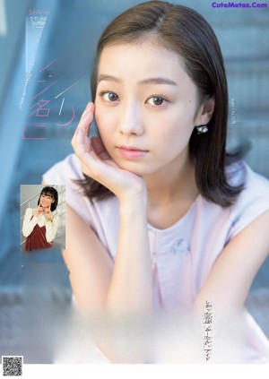 A woman in a white shirt and red skirt posing for a magazine.