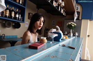 A naked woman sitting on top of a pool table.