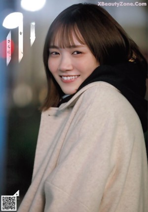 A close up of a person holding a yellow scarf.