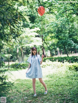 A woman in a blue shirt is posing for a picture.