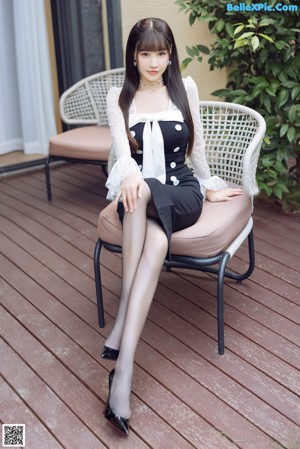 A woman in a cow costume sitting on a couch.