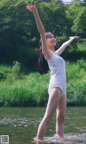 A woman in a black bikini posing for a picture.